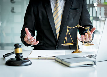 Lawyer with scales of justice—PAGA actions and legal impact of Kim v. Reins.