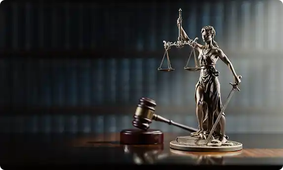 Lady Justice statue with a gavel, symbolizing legal integrity and justice.