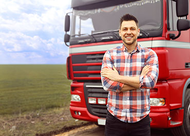 Truck driver standing confidently—legal rights of transportation employees in workplace disputes.